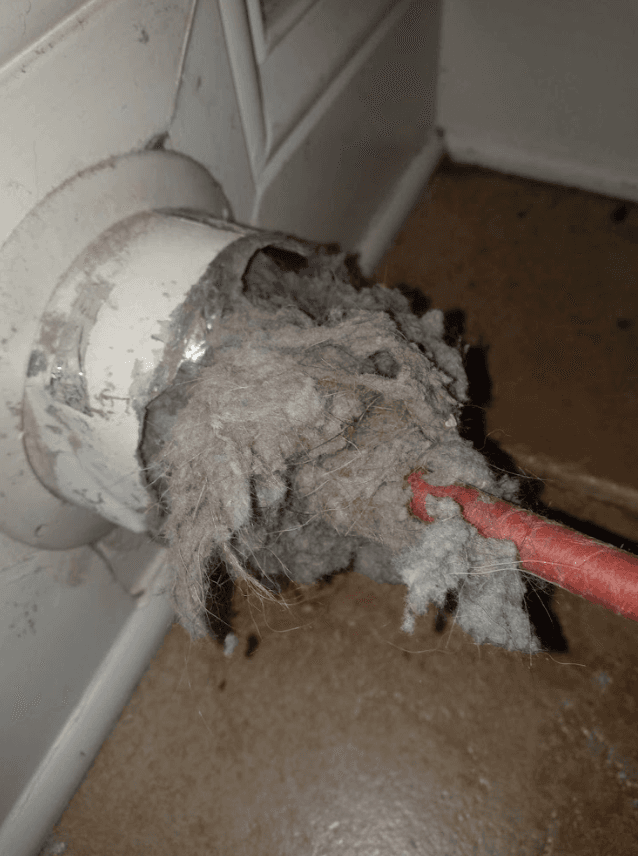 Severely clogged dryer vent with dense lint obstruction
