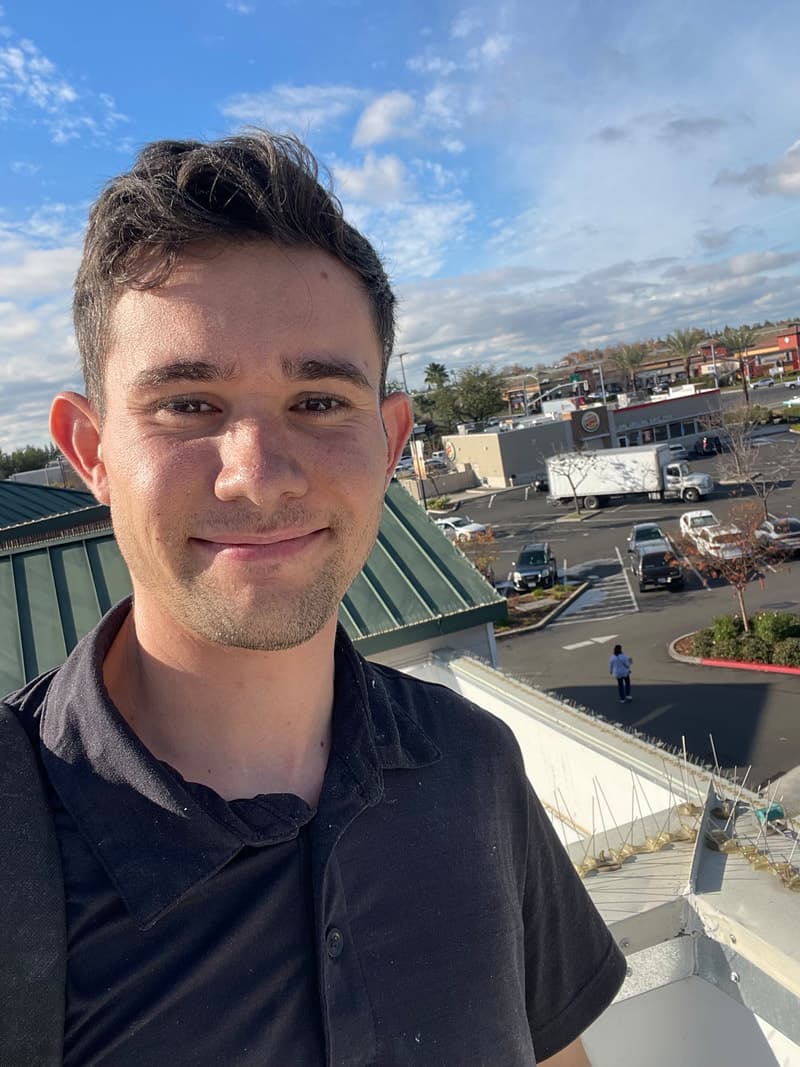 Service technician on rooftop for dryer vent cleaning